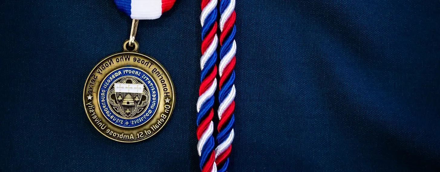 A medal and a ribbon adorning a blue shirt, symbolizing achievement and recognition for veteran service.